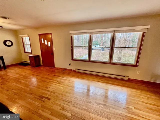 a balcony with wooden floor table and chairs