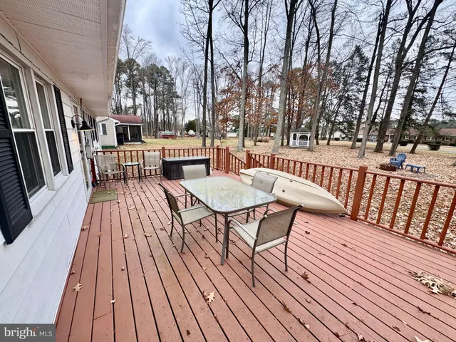 a front view of a house with a yard covered in snow