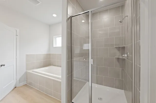 a bathroom with a bathtub and a shower
