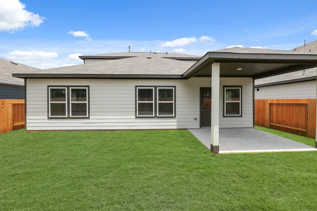 a view of an house with backyard space and balcony
