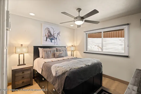 a bedroom with a large bed and a window