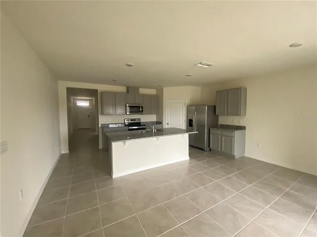 a kitchen with stainless steel appliances a refrigerator sink and cabinets
