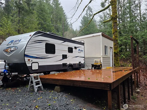 a backyard of a house with table and chairs