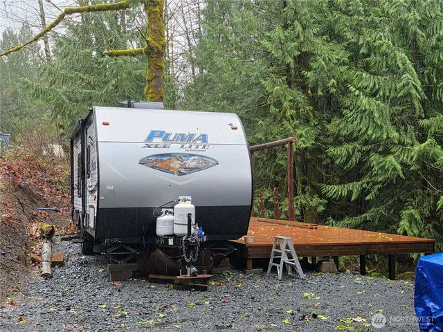 a view of a patio with table and chairs with wooden fence