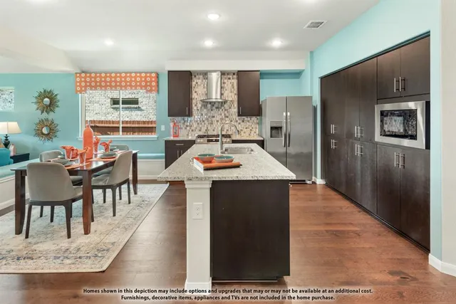 a living room with stainless steel appliances kitchen island granite countertop furniture and a dining table
