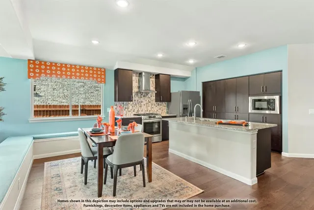 a dining room with furniture and a large window