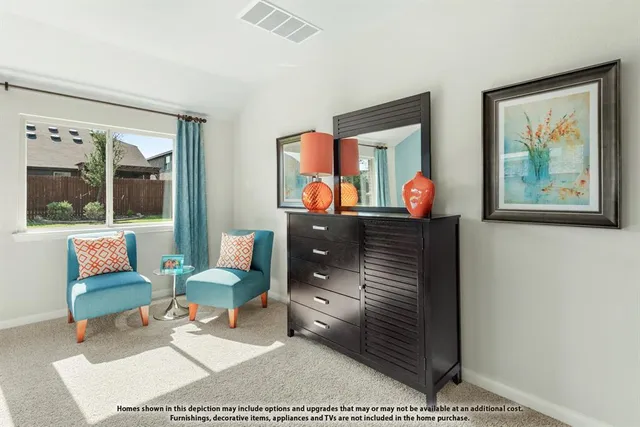 a living room with furniture and a painting on the wall