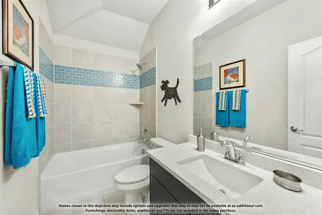 a bathroom with a granite countertop sink a toilet a mirror a bathtub and shower