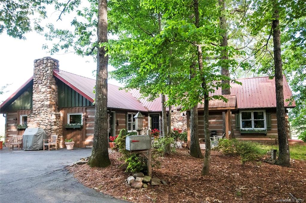 5911 Big Level Road Mill Spring, NC 28756 - Photo 3 of 47 a front view of a house with garden