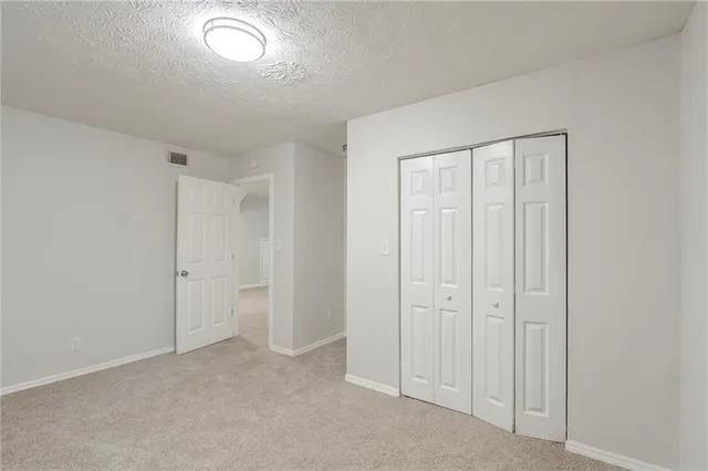 an empty room with closet area