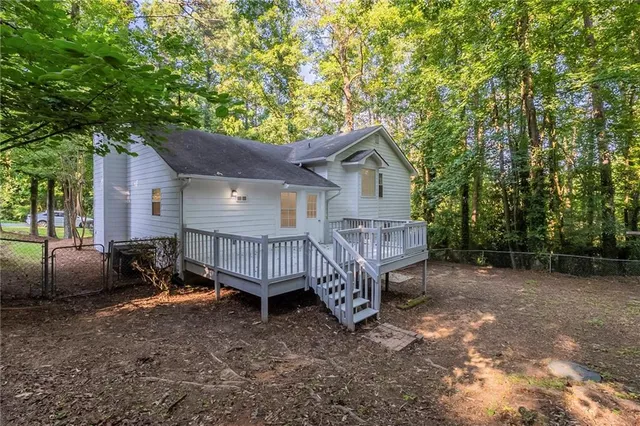 a view of a house with a yard and sitting area
