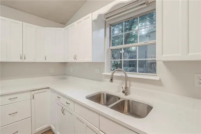a kitchen with a sink and cabinets
