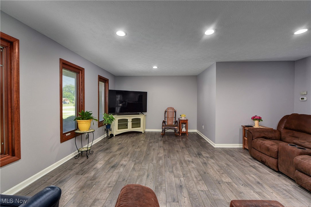 Living room featuring a textured ceiling and hardwood / wood-style floors