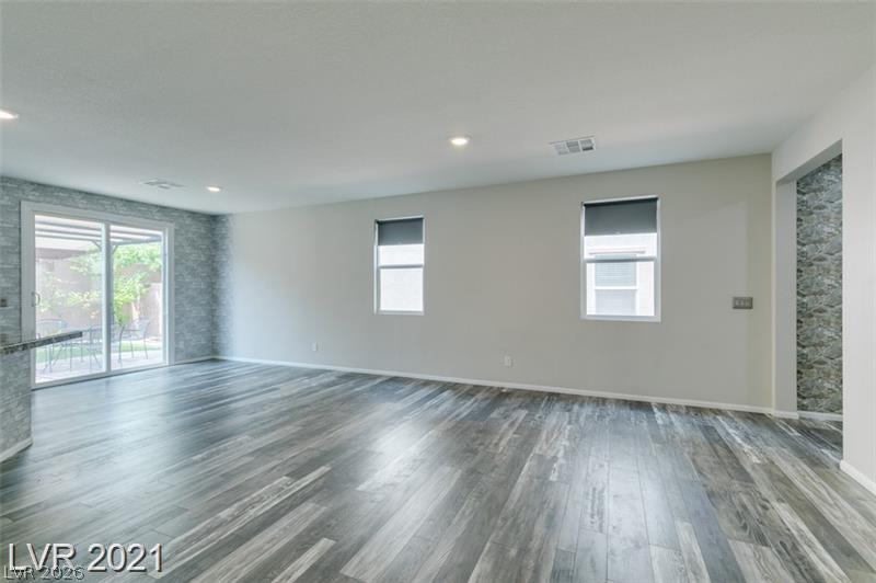 5475 Ordesa Valley Road Las Vegas, NV 89148 - Photo 30 of 35 A spacious room offers durable wood-look flooring and easy outdoor access through a sliding glass door.