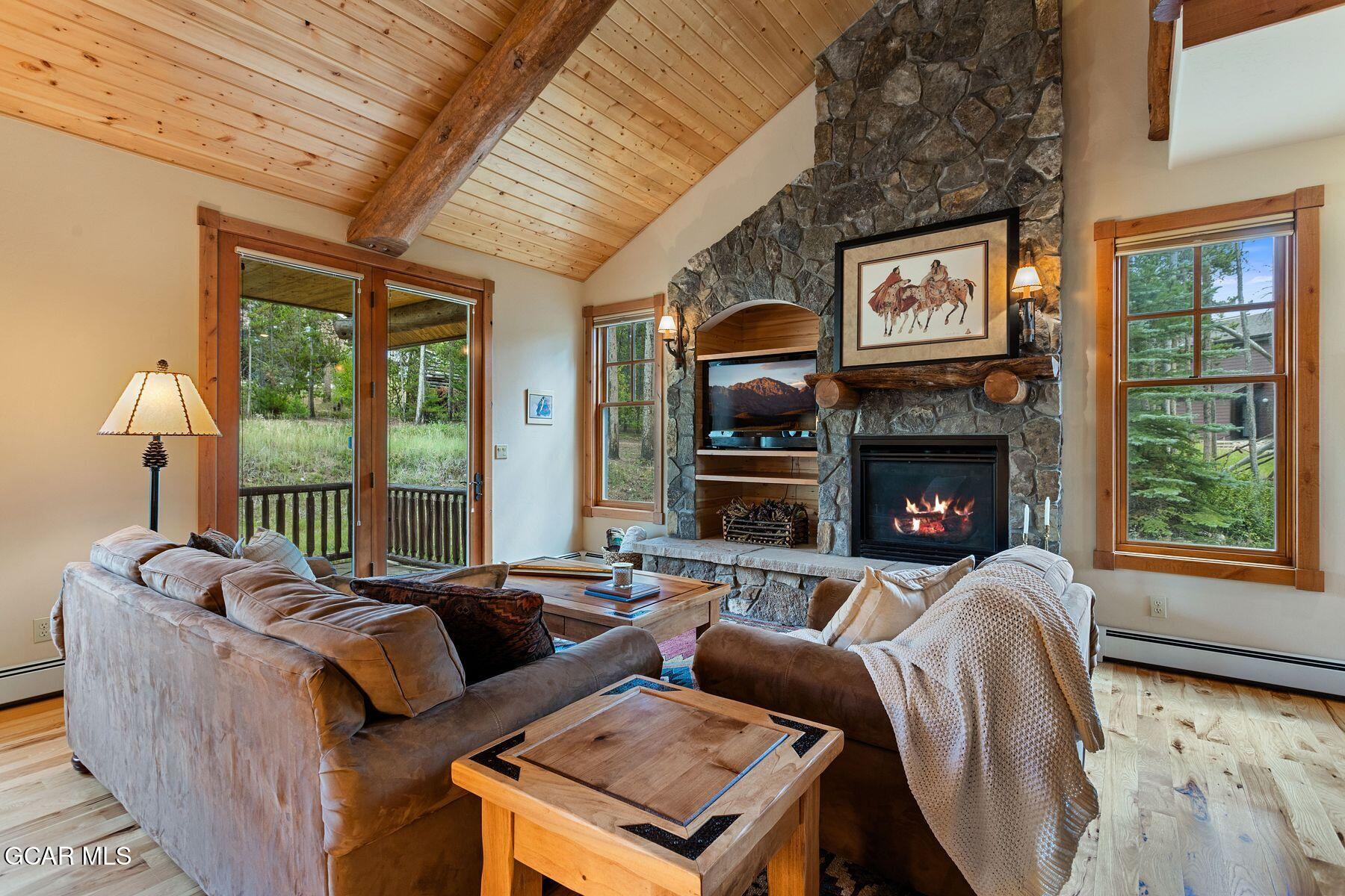 445 Trappers Way Fraser, CO 80442 - Photo 14 of 37 a living room with furniture a large window and a fireplace