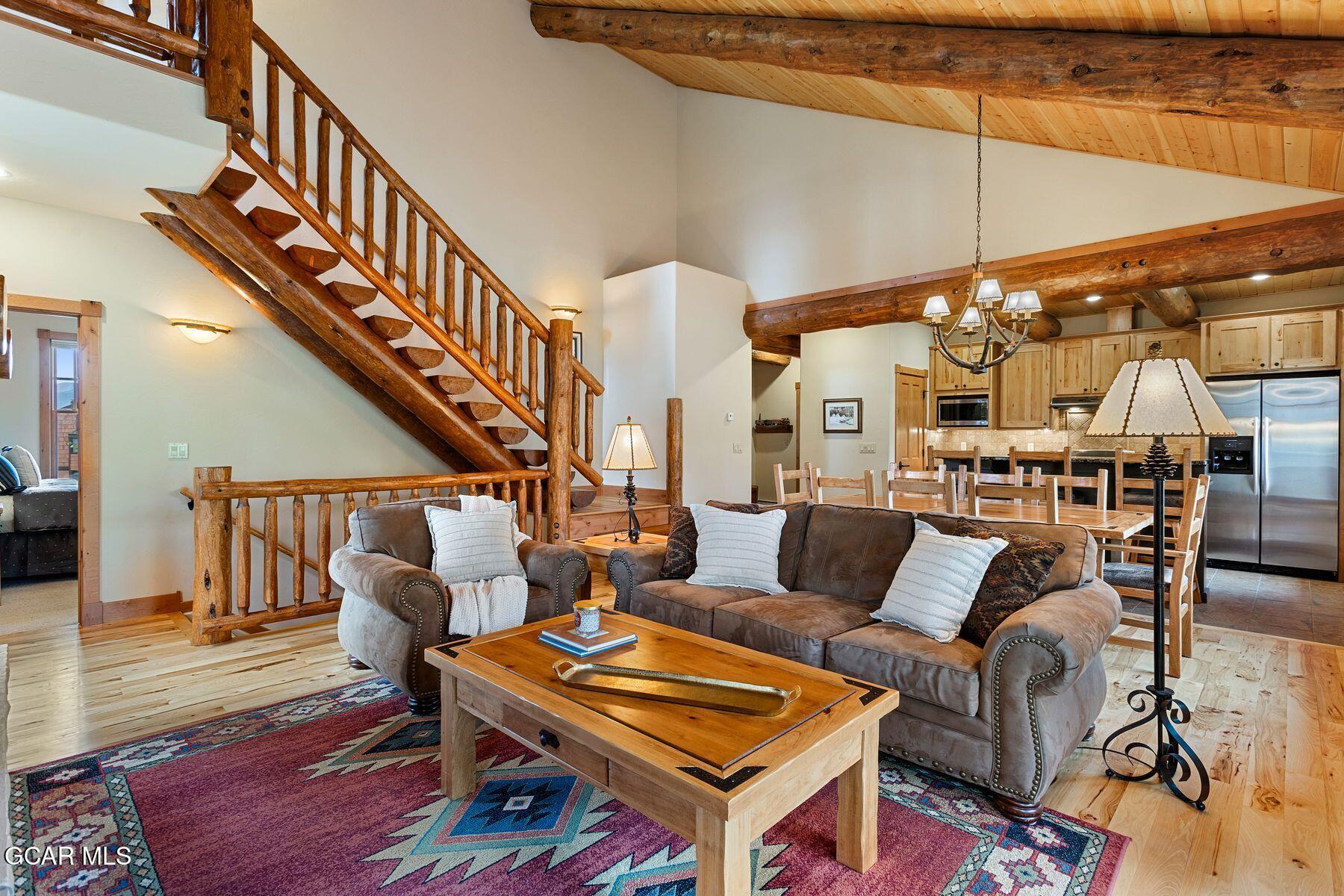 445 Trappers Way Fraser, CO 80442 - Photo 16 of 37 a living room with lots of furniture and a dining table with wooden floor