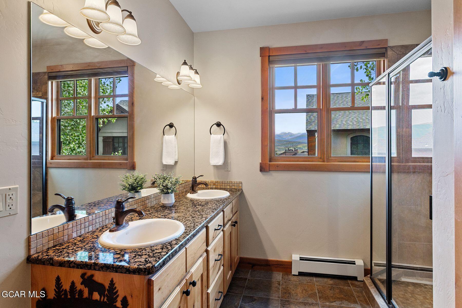 445 Trappers Way Fraser, CO 80442 - Photo 25 of 37 a bathroom with a sink and a mirror