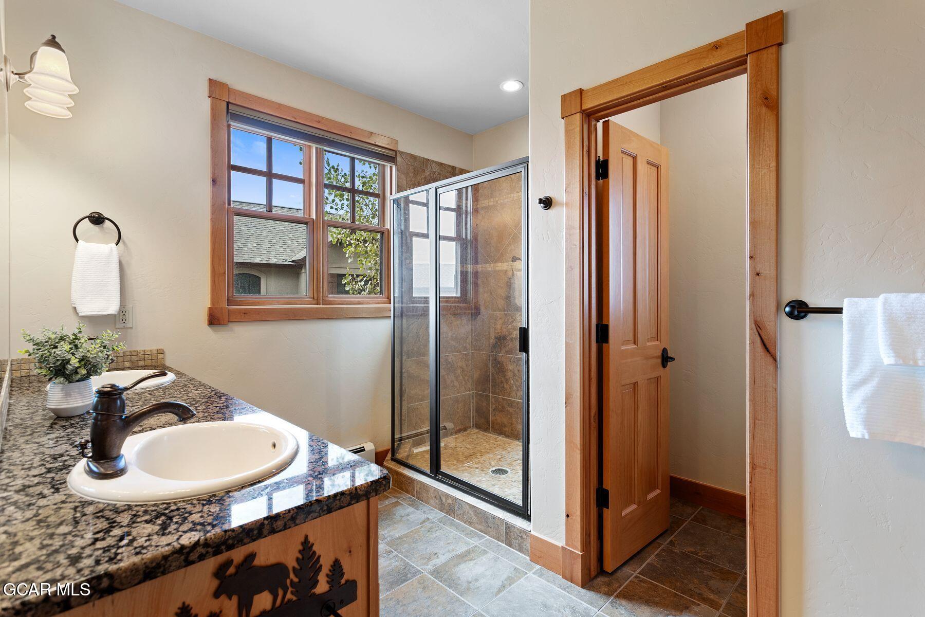 445 Trappers Way Fraser, CO 80442 - Photo 26 of 37 a bathroom with a sink and a mirror