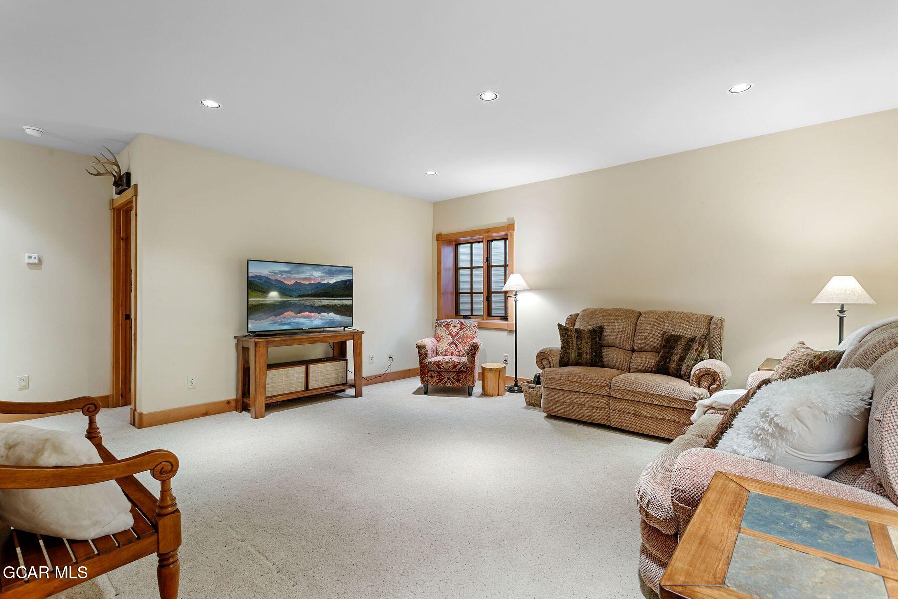 445 Trappers Way Fraser, CO 80442 - Photo 27 of 37 a living room with furniture and a lamp