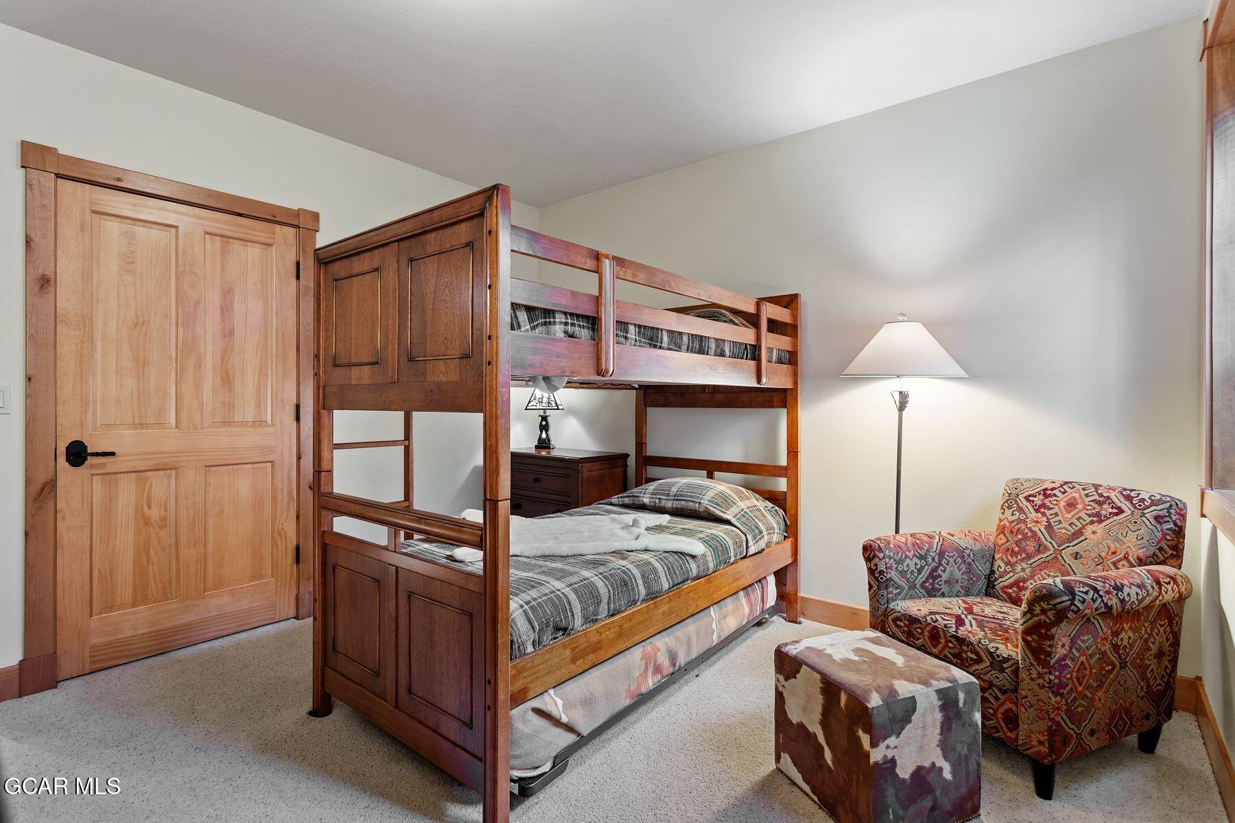 445 Trappers Way Fraser, CO 80442 - Photo 32 of 37 a bedroom with a bed and a lamp