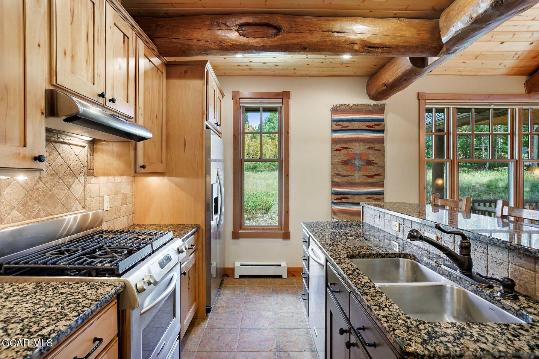 445 Trappers Way Fraser, CO 80442 - Photo 8 of 37 a kitchen with a sink stove and cabinets