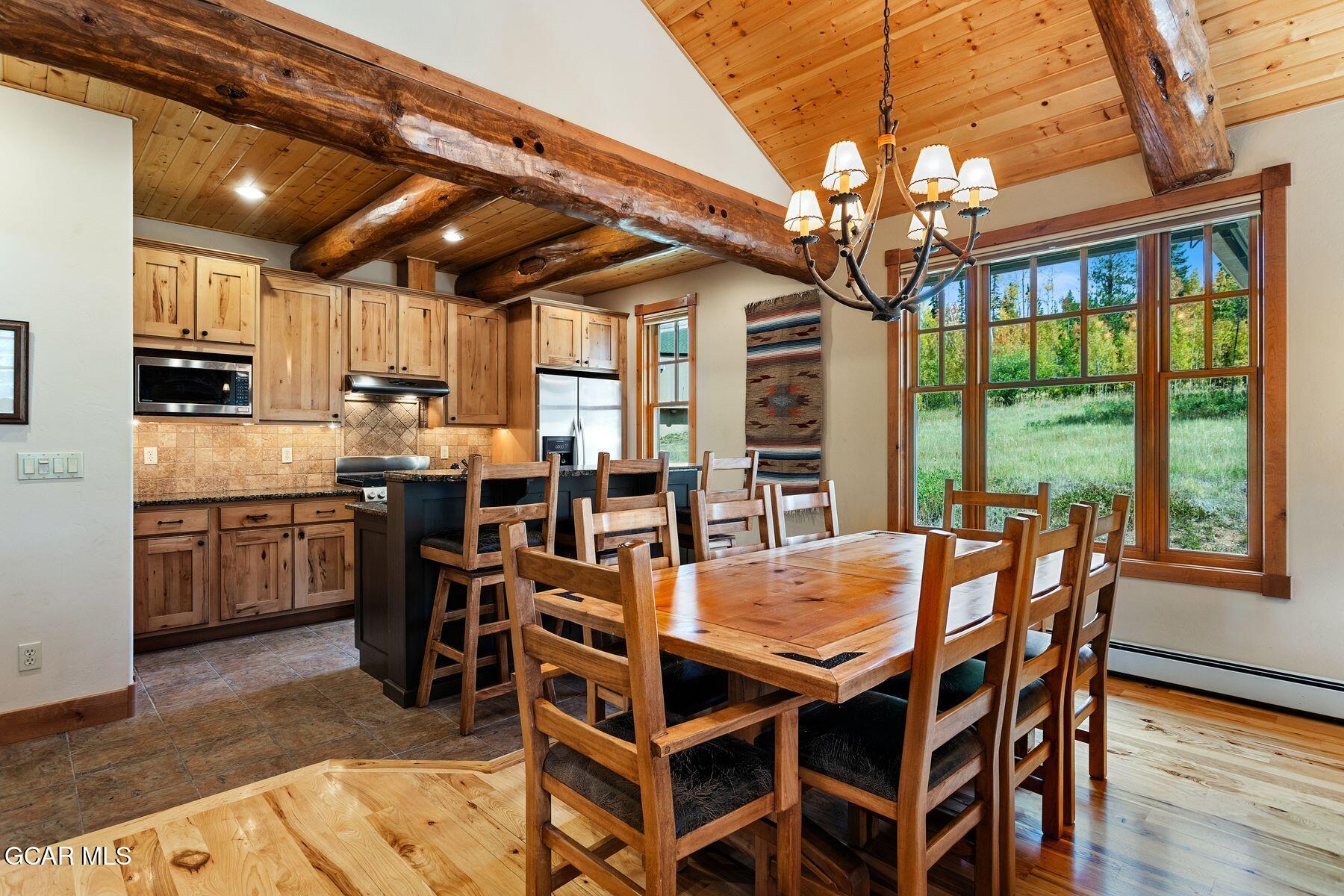 445 Trappers Way Fraser, CO 80442 - Photo 10 of 37 a view of a dining room with furniture window and wooden floor