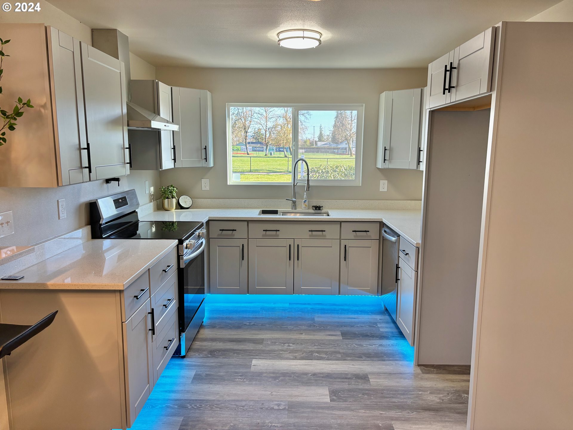 2140 J Street Springfield, OR 97477 - Photo 10 of 23 a kitchen with stainless steel appliances granite countertop a sink stove and refrigerator