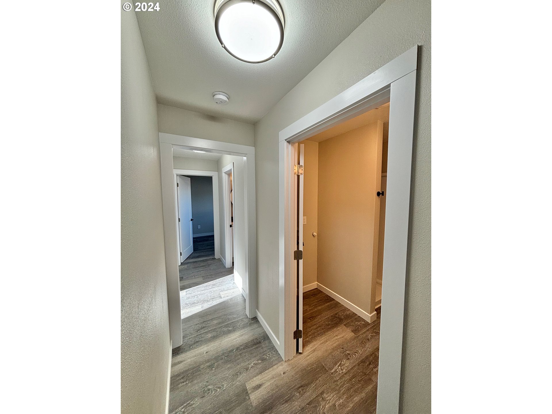 2140 J Street Springfield, OR 97477 - Photo 14 of 23 a view of a hallway with wooden floor and a bathroom