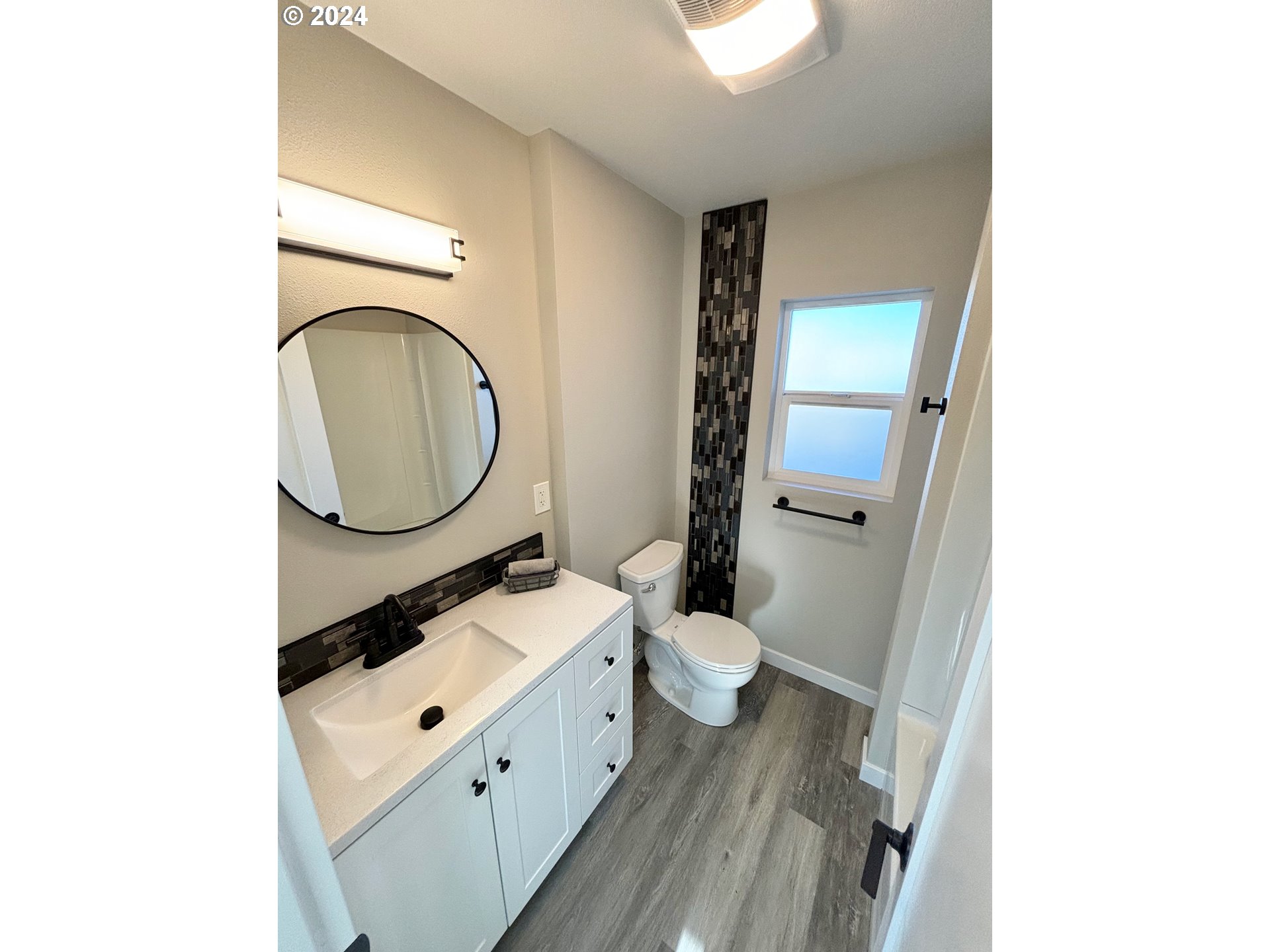 2140 J Street Springfield, OR 97477 - Photo 17 of 23 a bathroom with a toilet sink and mirror