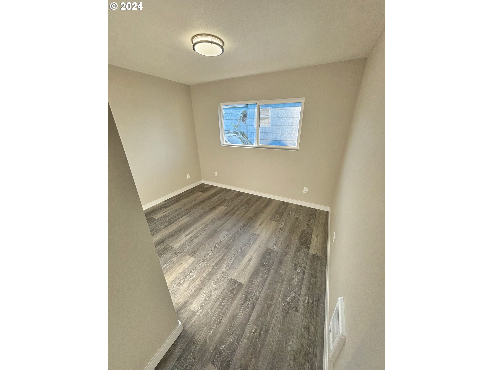 2140 J Street Springfield, OR 97477 - Photo 18 of 23 a view of a hallway with wooden floor
