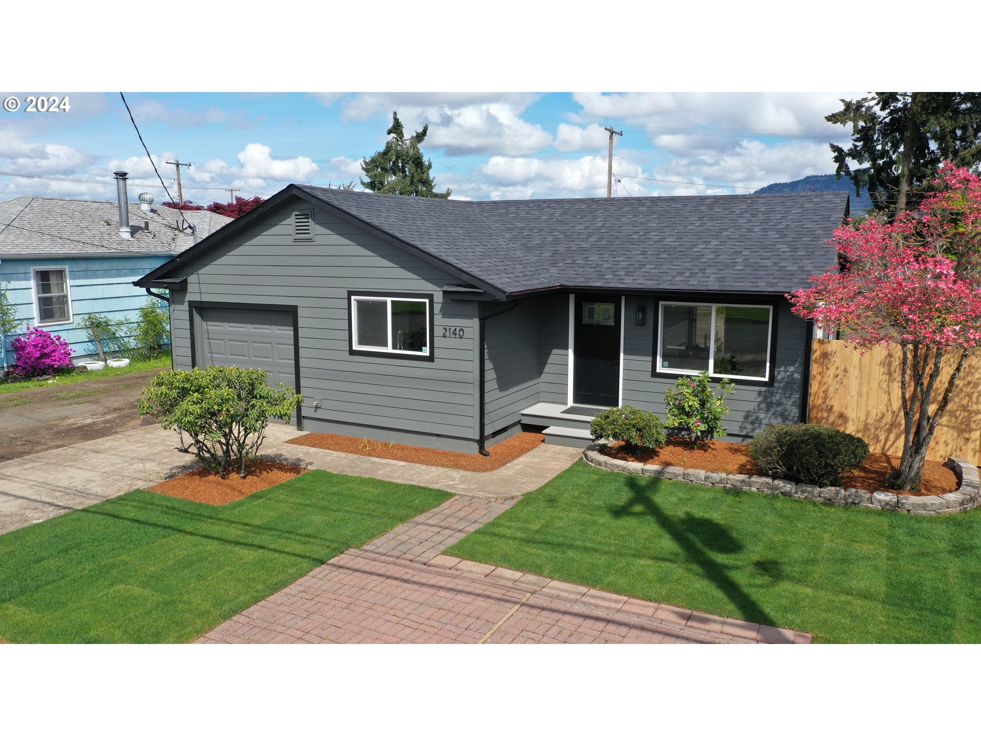 2140 J Street Springfield, OR 97477 - Photo 2 of 23 a backyard of a house with wooden fence table and chairs