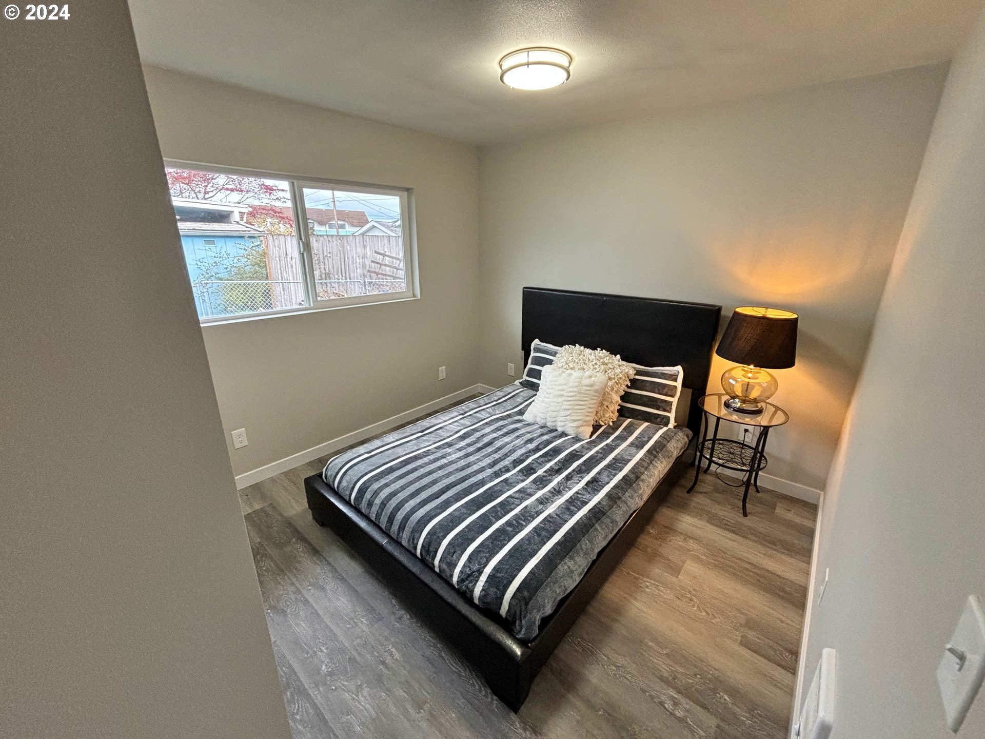 2140 J Street Springfield, OR 97477 - Photo 19 of 23 a bedroom with a bed and wooden floor
