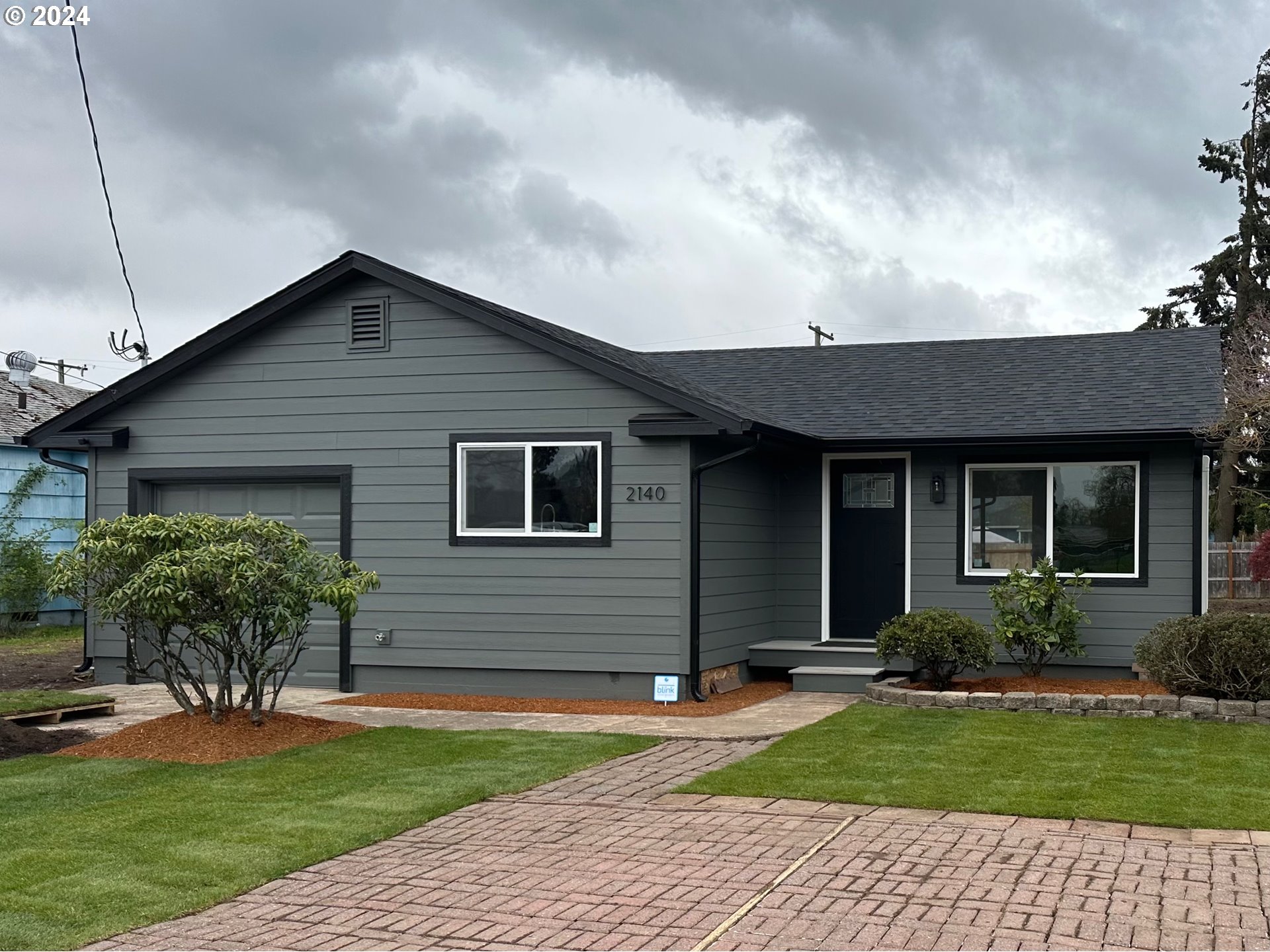 2140 J Street Springfield, OR 97477 - Photo 3 of 23 a front view of a house with a yard and potted plants