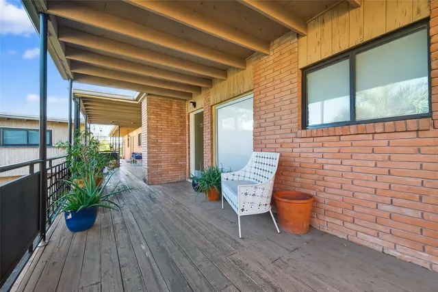 a view of a chairs and table on the wooden deck