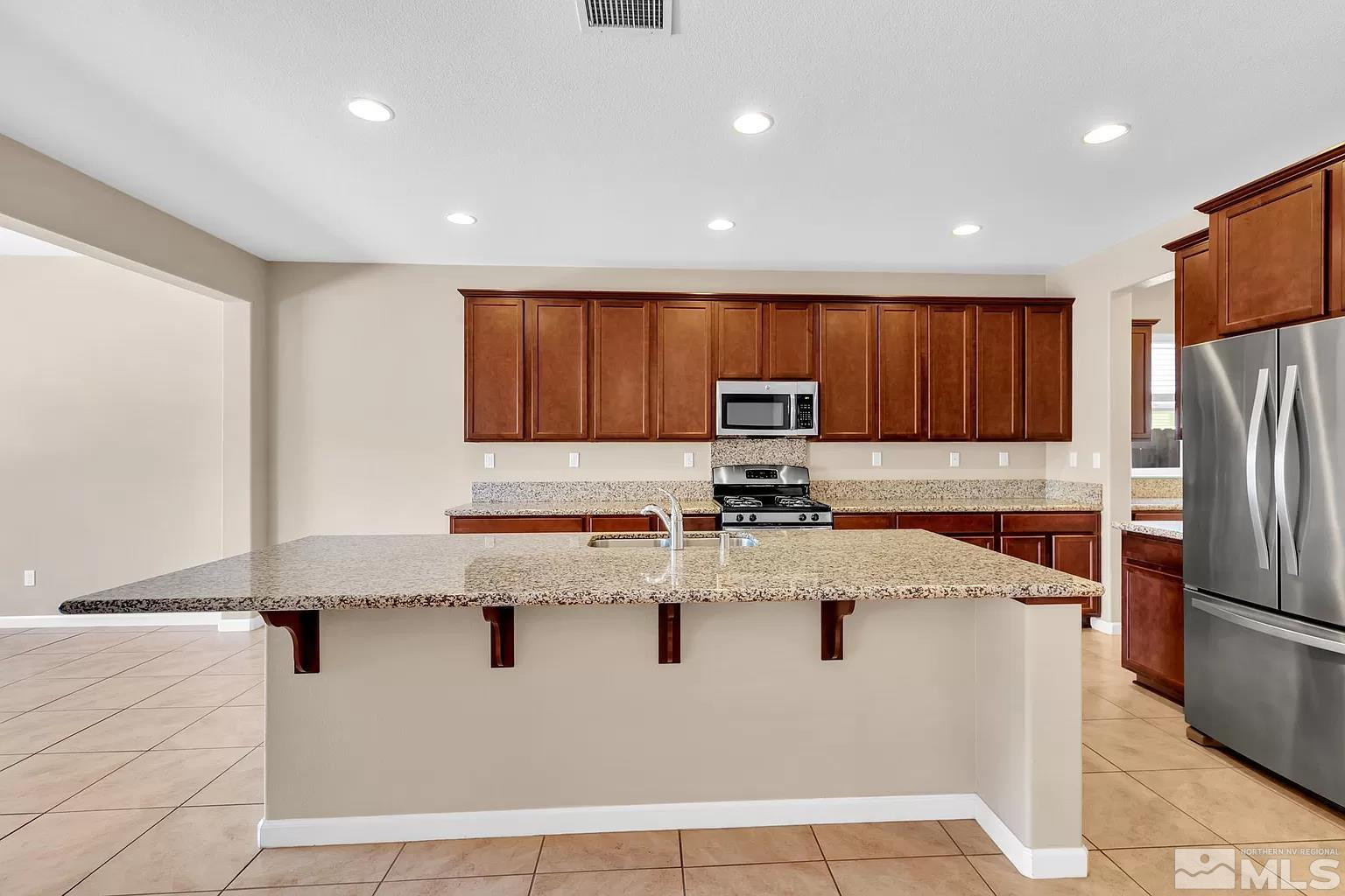 1925 Dutch Draft Drive Reno, NV 89521 - Photo 4 of 10 a kitchen with granite countertop a refrigerator and a sink