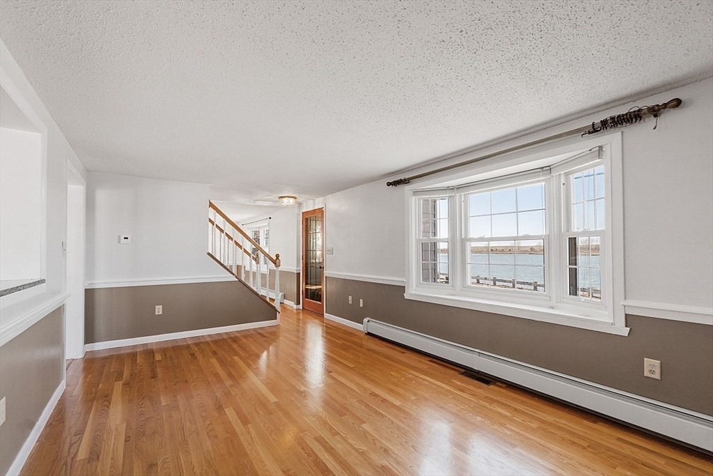 163 Mills Avenue Revere, MA 02151 - Photo 16 of 22 a view of empty room with wooden floor and fan