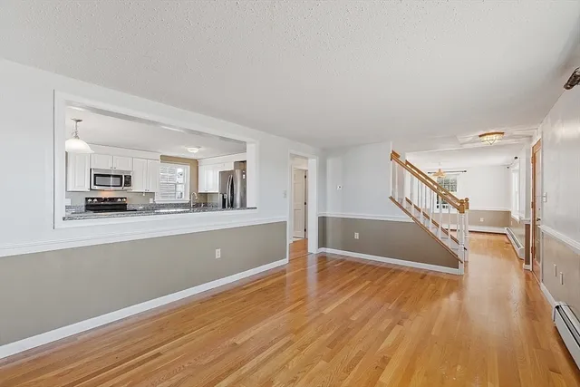 a kitchen with granite countertop a stove top oven a sink dishwasher and a microwave oven with cabinets