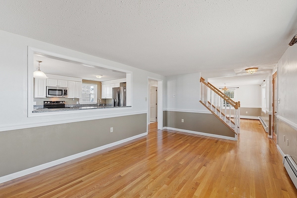 163 Mills Avenue Revere, MA 02151 - Photo 17 of 22 a living room with wooden floor and large windows