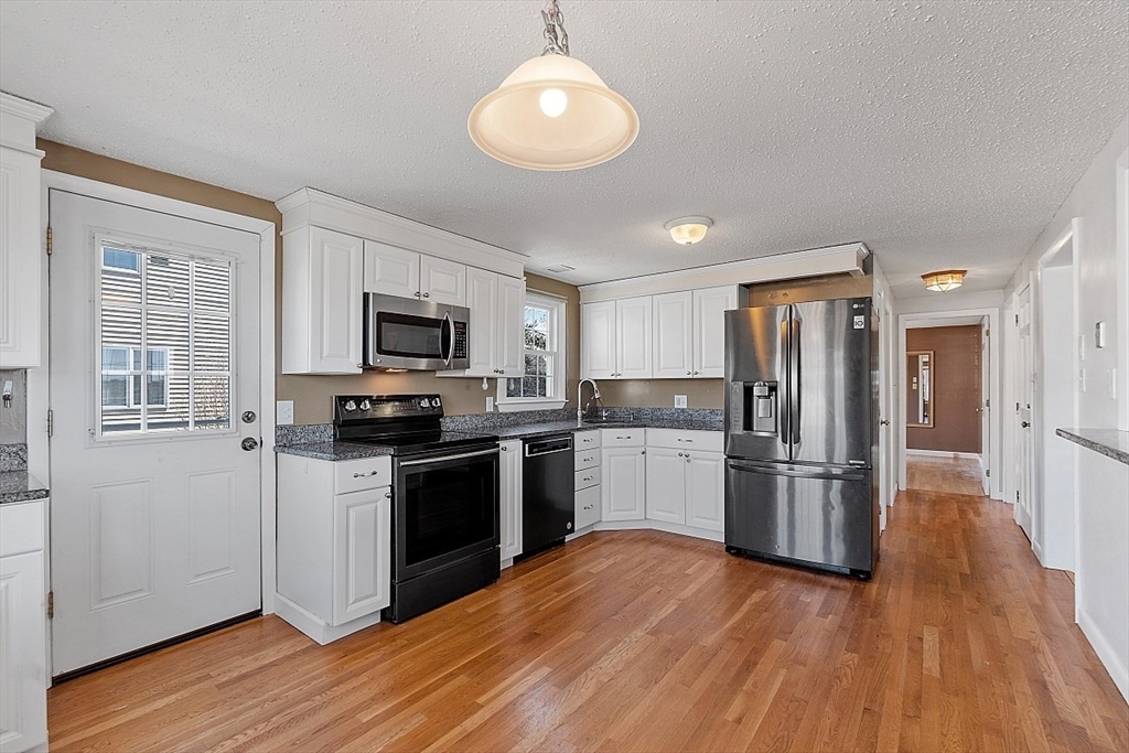 163 Mills Avenue Revere, MA 02151 - Photo 19 of 22 a kitchen with a refrigerator stove and microwave