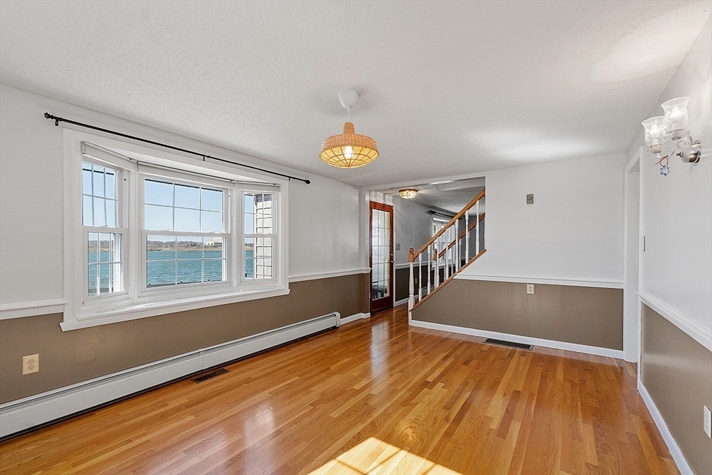 163 Mills Avenue Revere, MA 02151 - Photo 21 of 22 a view of empty room with wooden floor and fan
