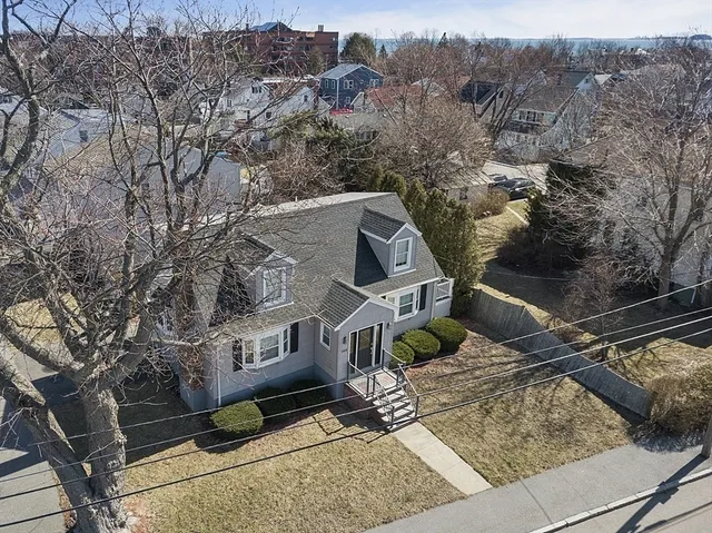 an aerial view of a house with a yard