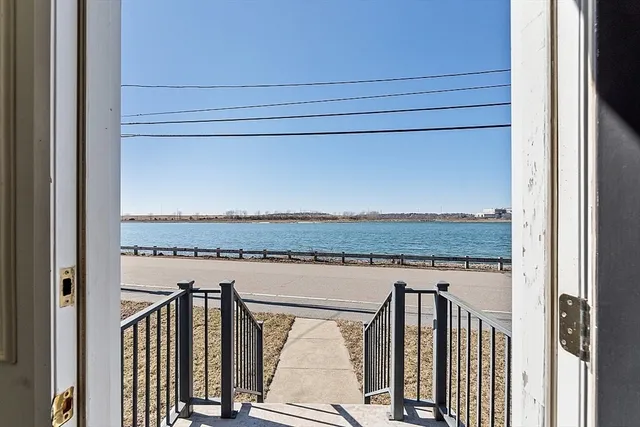 an aerial view of a building and ocean