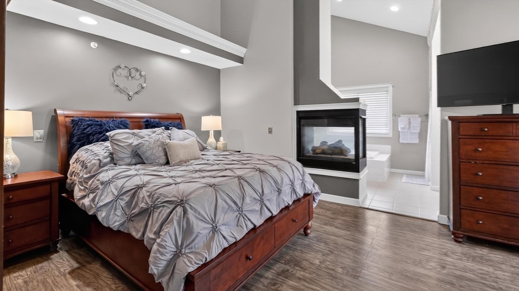 5 Governors Way, Unit B Milford, MA 01757 - Photo 24 of 42 a bedroom with a bed and a flat screen tv