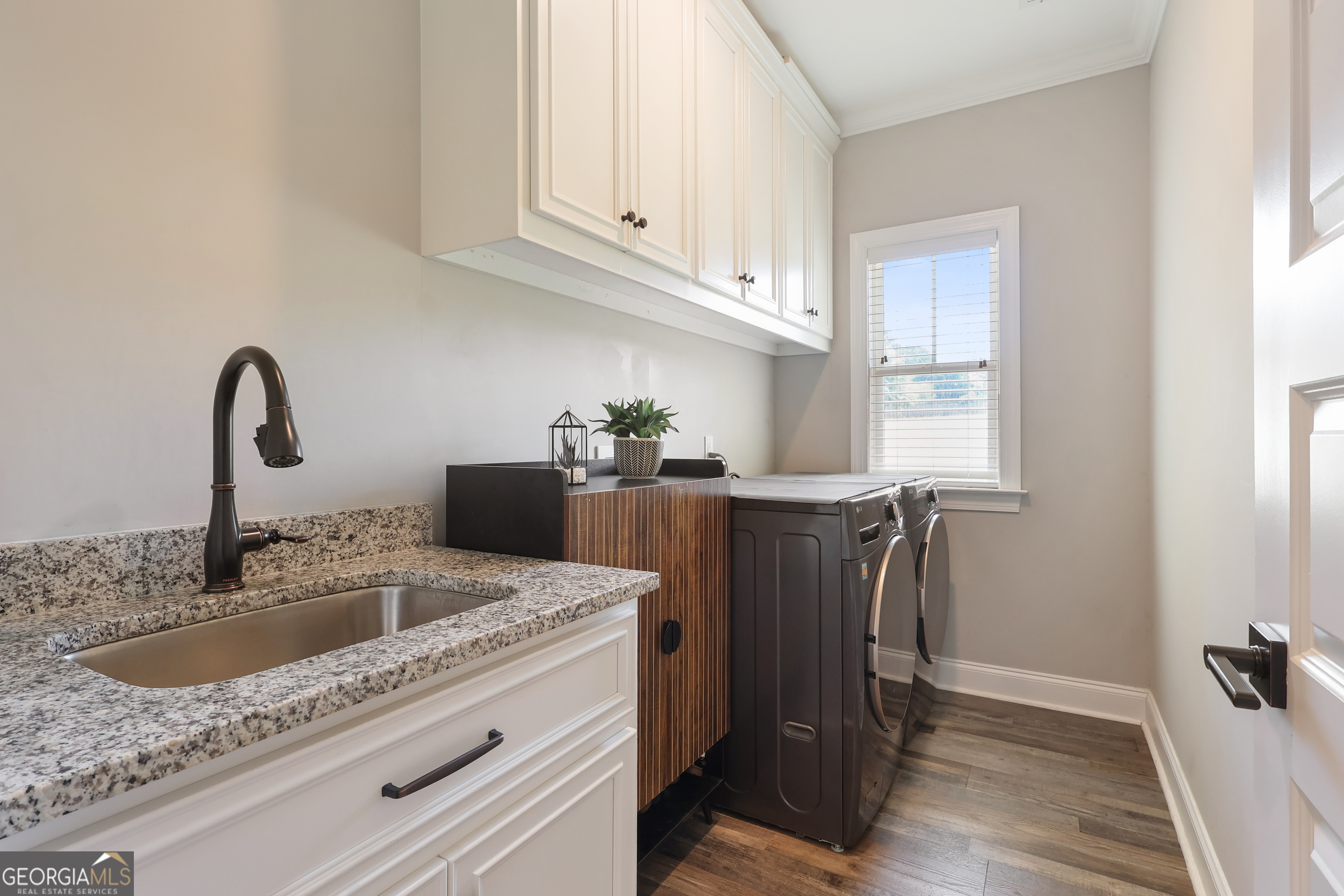 89 Claire Road Forsyth, GA 31029 - Photo 8 of 40 a kitchen with stainless steel appliances granite countertop a sink a window and cabinets