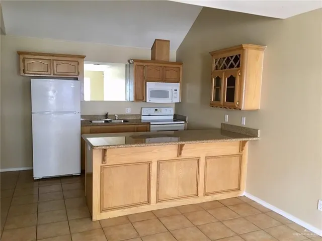 a kitchen with stainless steel appliances a sink stove and cabinets