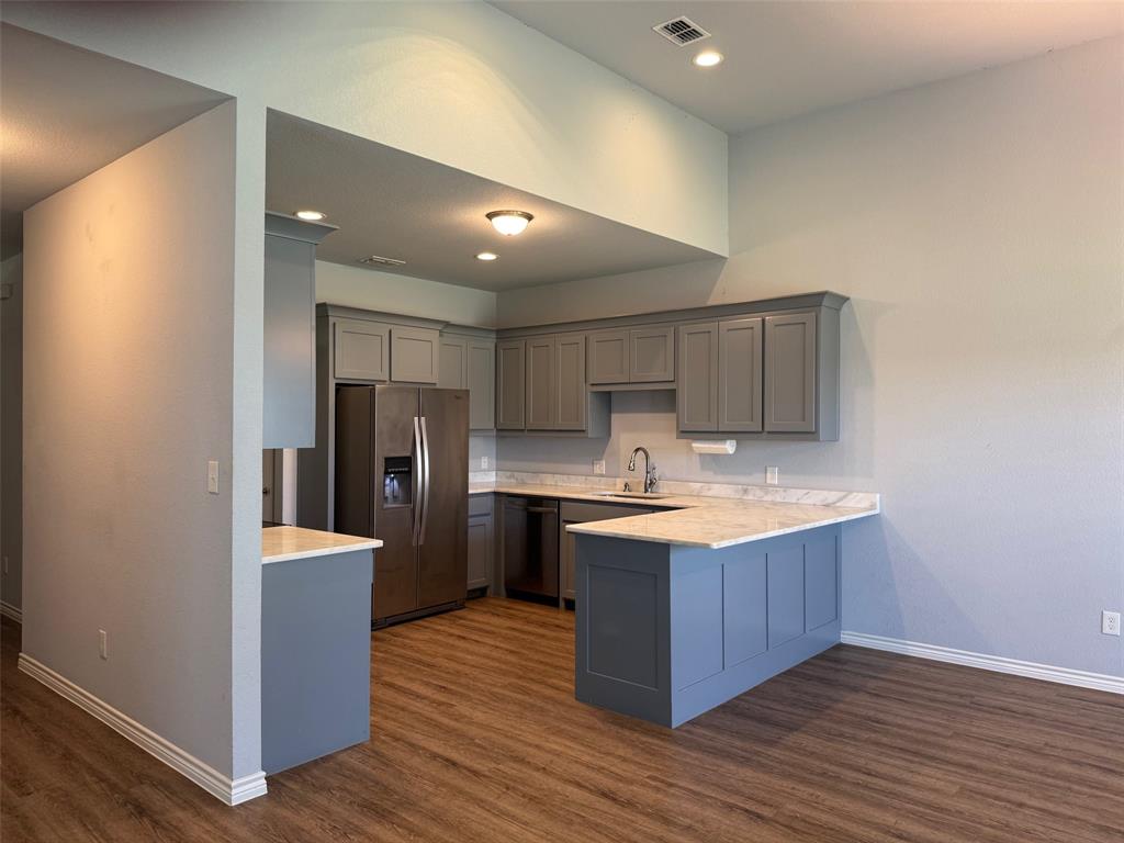 792 East Northside Drive Pilot Point, TX 76258 - Photo 5 of 18 a kitchen with stainless steel appliances granite countertop a stove and a refrigerator