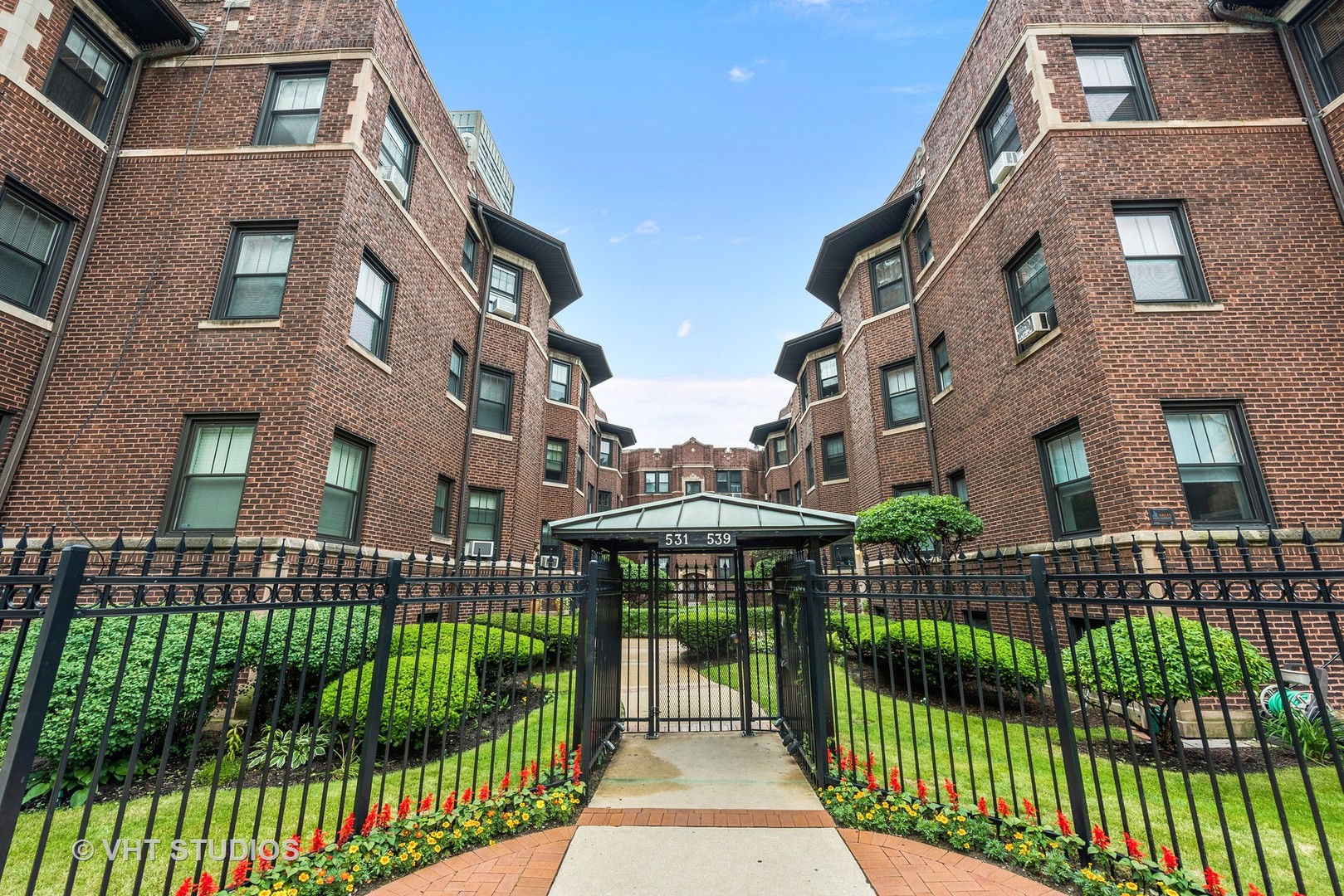 535 West Addison Street, Unit 2E Chicago, IL 60613 - Photo 1 of 11 a view of a brick house with many windows