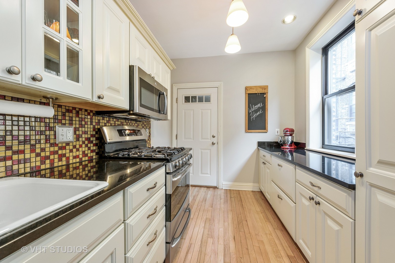 535 West Addison Street, Unit 2E Chicago, IL 60613 - Photo 6 of 11 a kitchen with stainless steel appliances granite countertop a stove and a sink