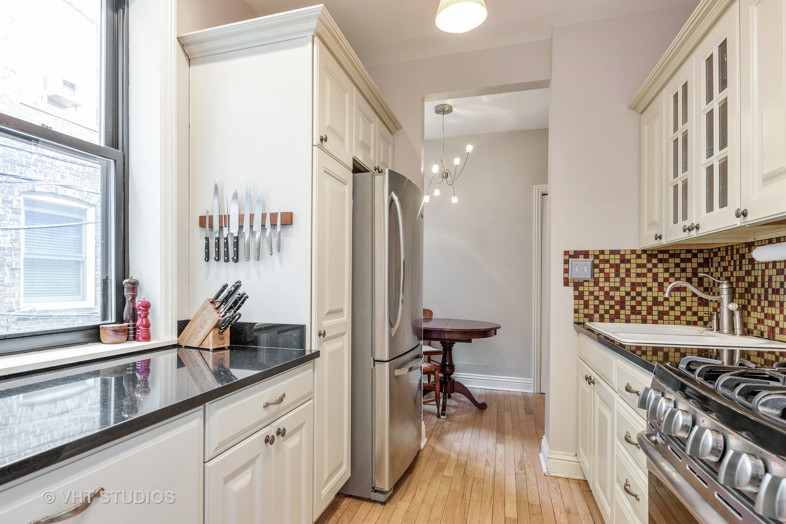 535 West Addison Street, Unit 2E Chicago, IL 60613 - Photo 7 of 11 a kitchen with sink stove and cabinets