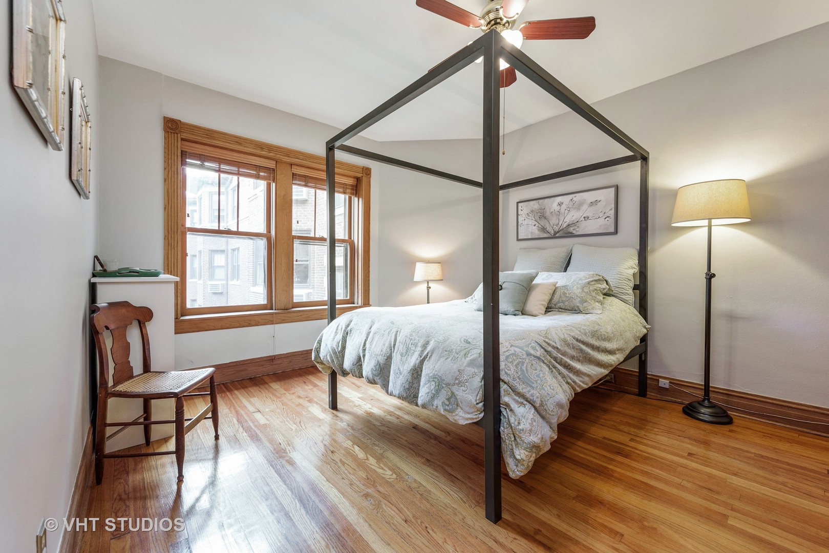 535 West Addison Street, Unit 2E Chicago, IL 60613 - Photo 9 of 11 a bedroom with a bed and wooden floor